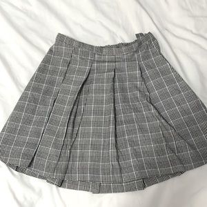 Black and white pleated skirt with a pop of blue